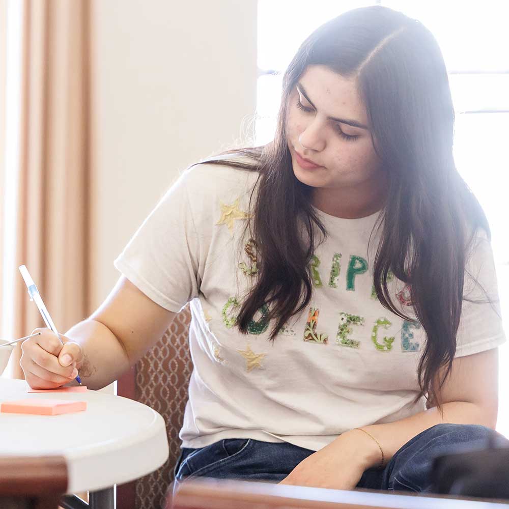 Student writing in a notebook
