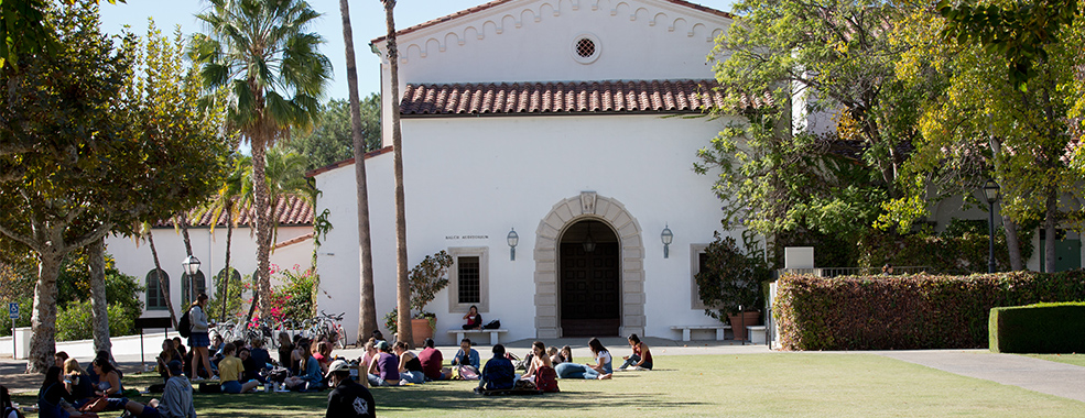 Scripps students sitting on a green lawn