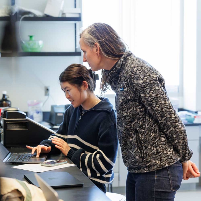 Student with professor in lab