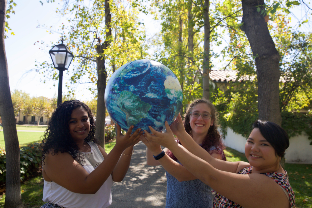 students holding a globe