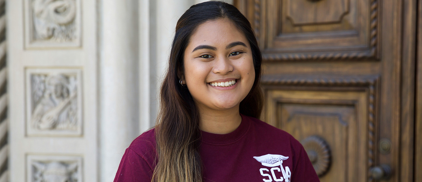 Scripps College Academy student standing in front of Denison Doors