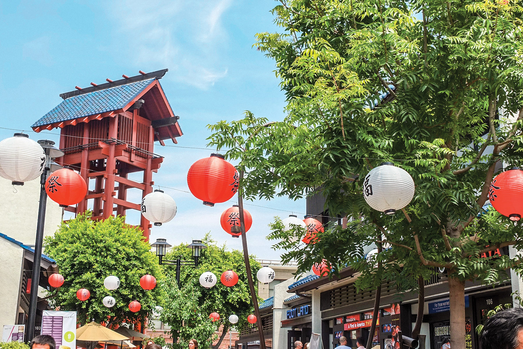 Red and white lanterns hanging in Little Tokyo on a sunny day.