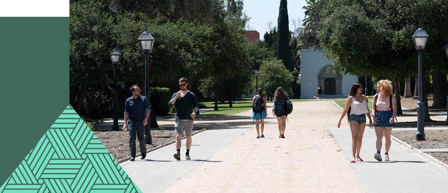 Multiple students walking outside on a path