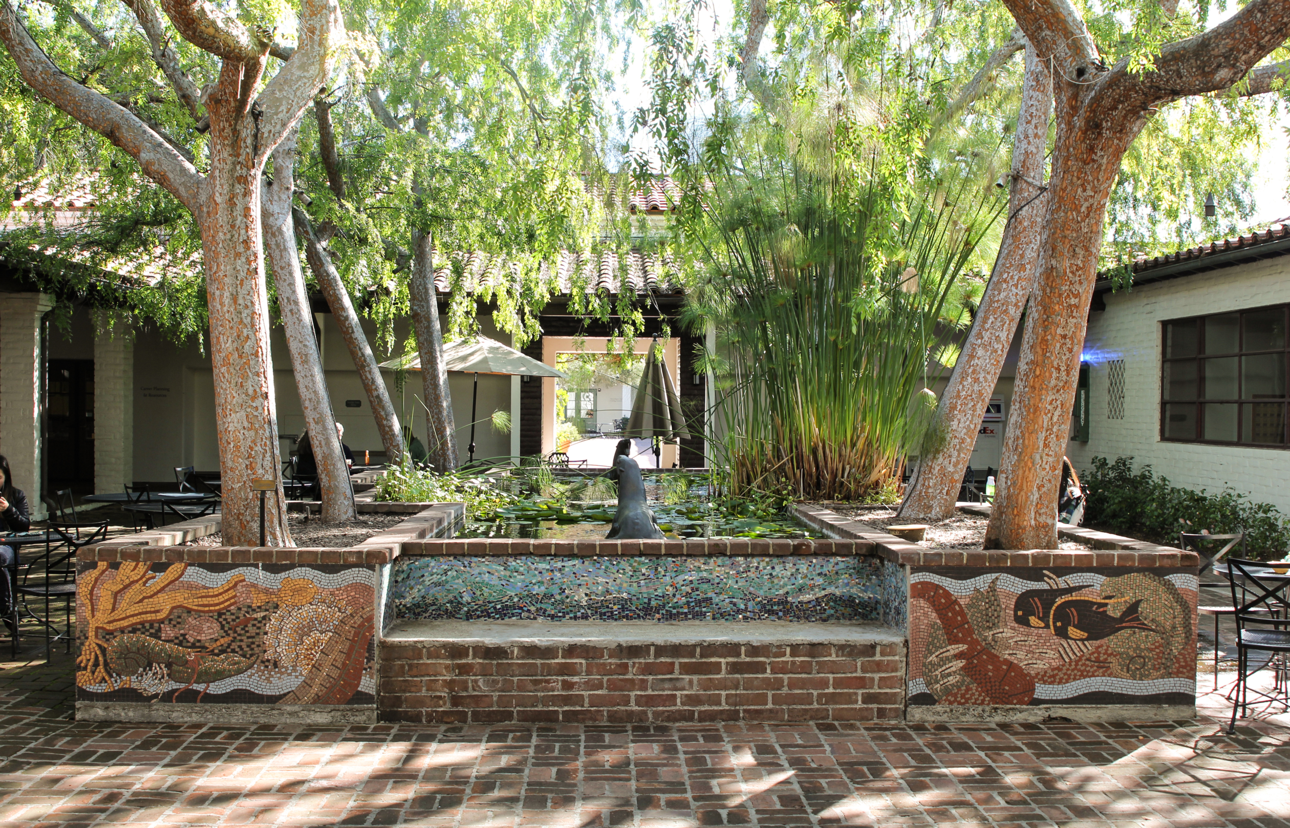 Courtyard with seal sculpture lined with trees