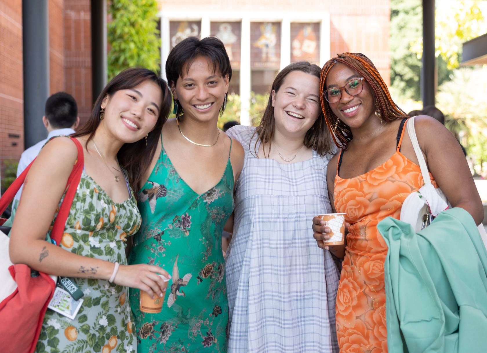 Four students posing for camera in dresses