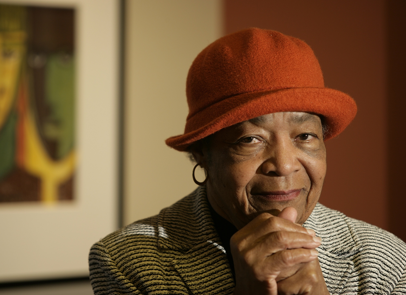 Image of Dr. Lewis, a black woman wearing a red hat