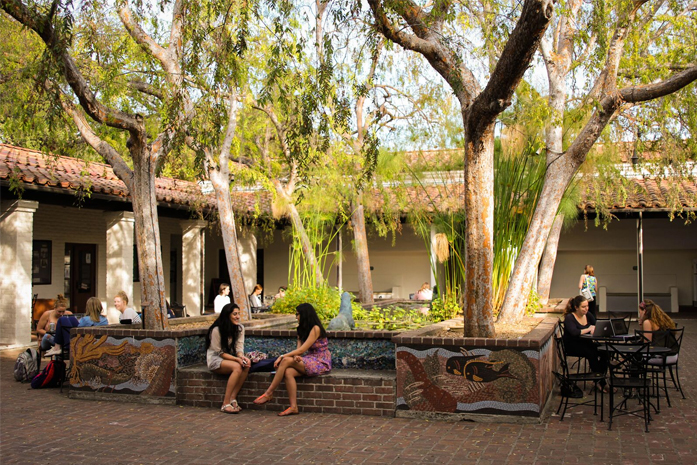 People sitting and talking in Seal Court at Scripps College.