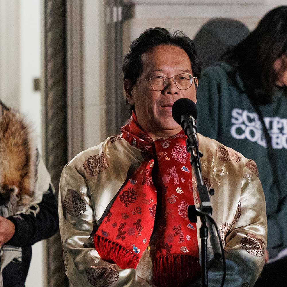 Hao Huang at a microphone outside Balch Auditorium