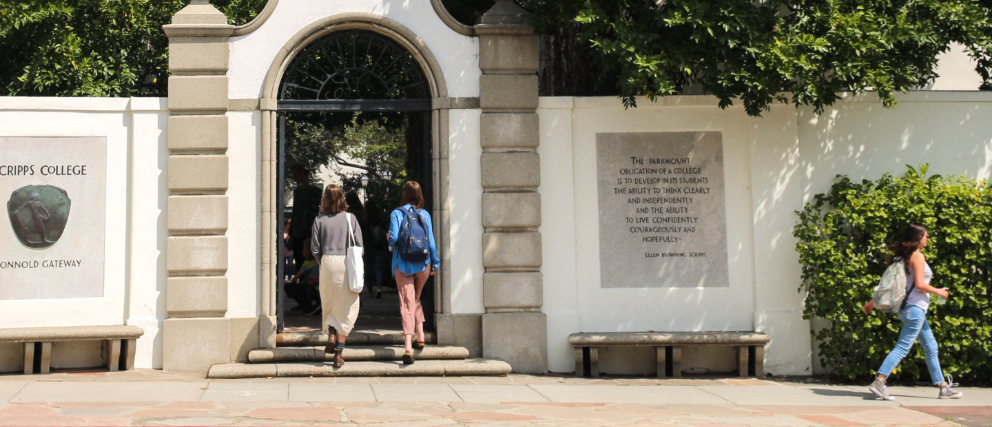 Two students walking through Honnold gate at Scripps College
