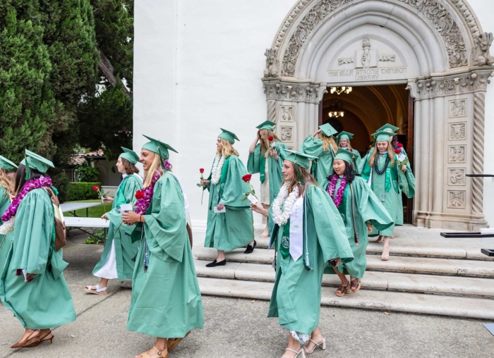 Students at Commencement walking out of Denison Doors
