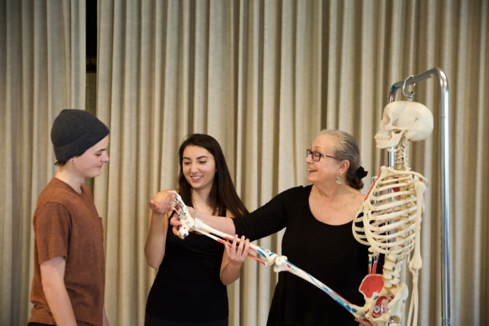 Professor of Dance Ronnie Brosterman (right) uses "Lori" the skeleton as a teaching tool. Also pictured: Devon Frost '20 (left) and Ana Nishioka '19 (center)