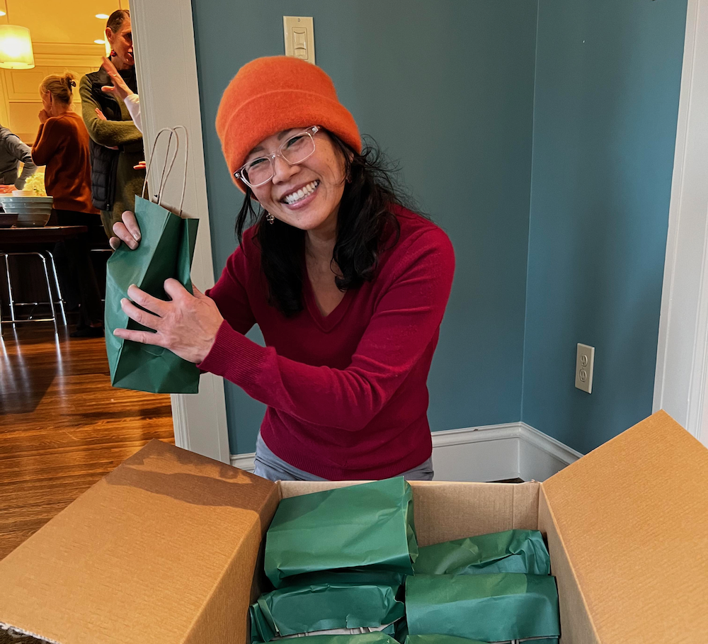 Scripps parent holding up a gift at a care package party in Seattle