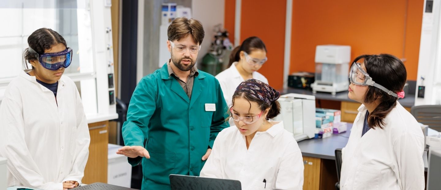 science students confer with a professor