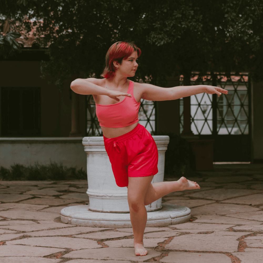 Student strikes a dance pose in Margaret Fowler Garden