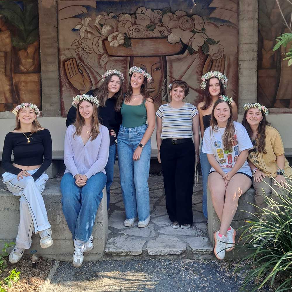 Image of the Laspa interns in Margaret Fowler Garden wearing flower crowns