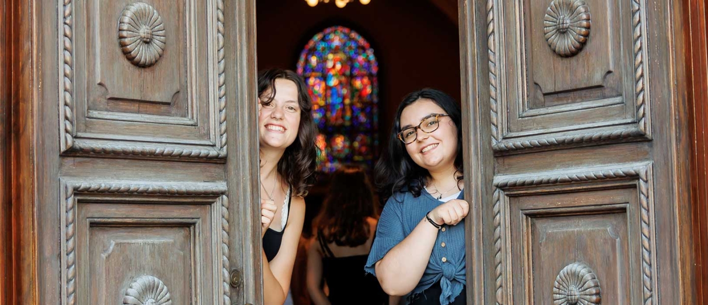 Scripps College students pose behind the door.