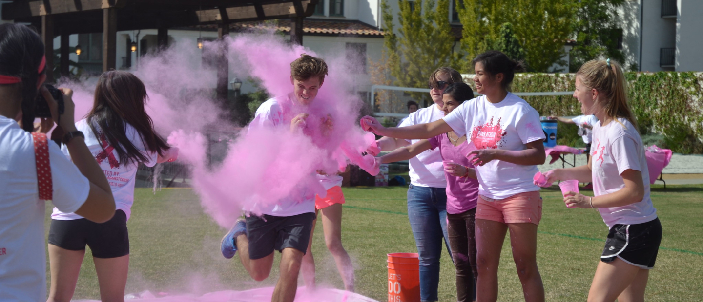 Students playing with pink dye