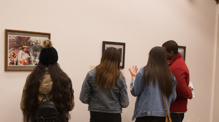 Students admire artwork.