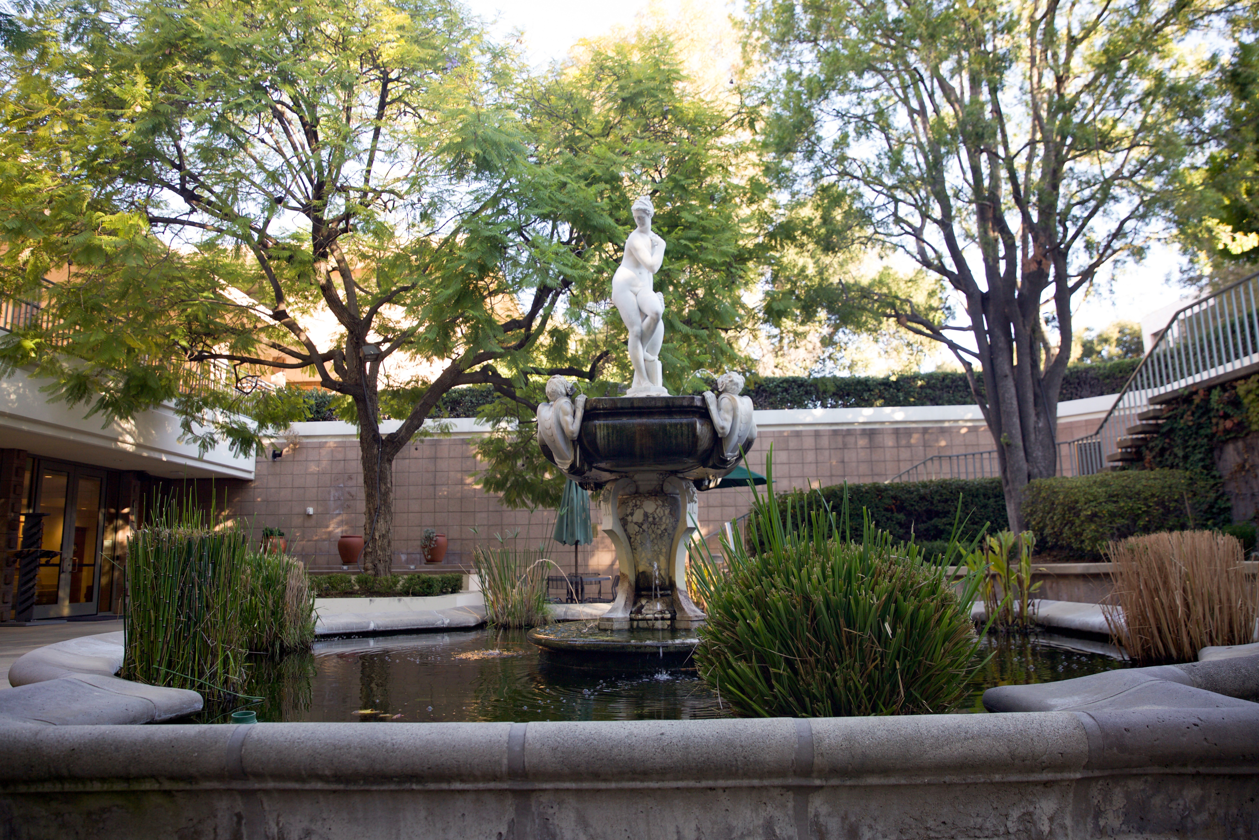 A fountain topped with a statue of a woman.