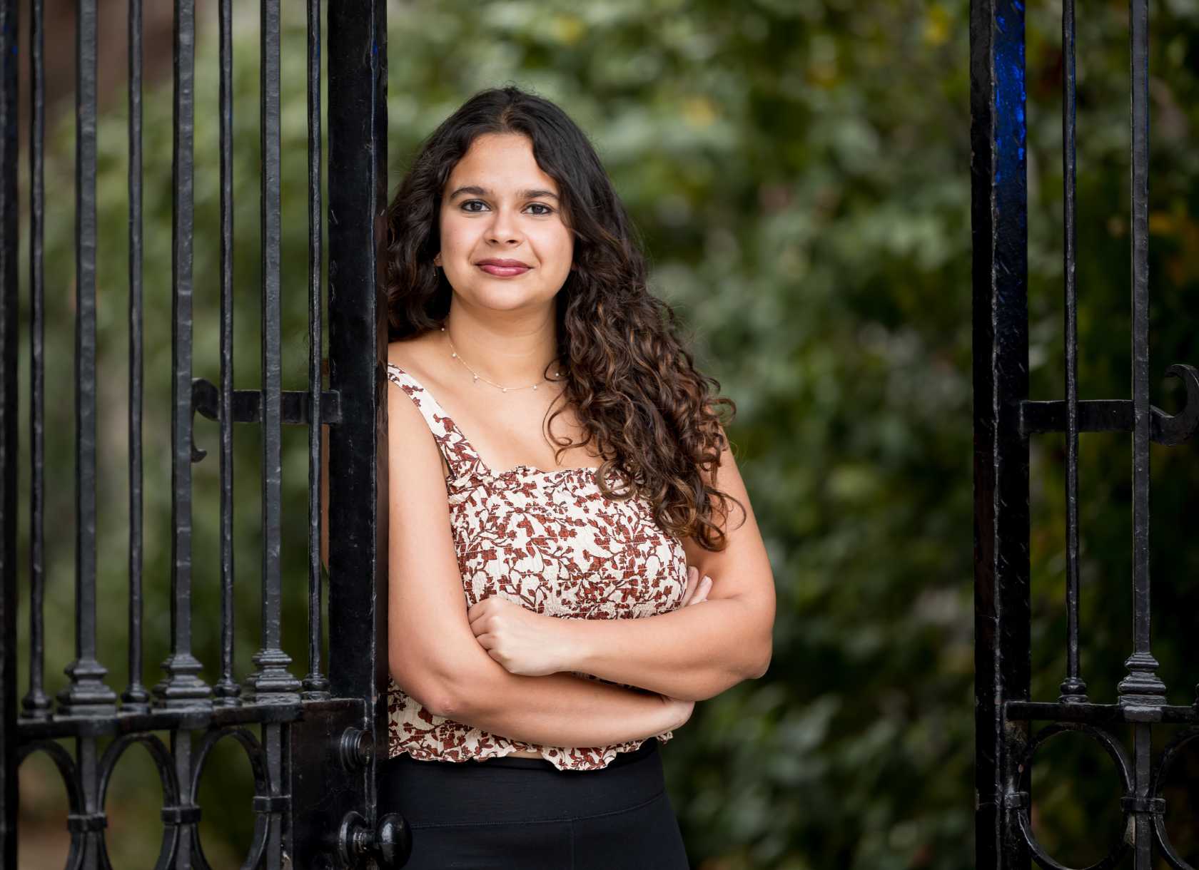 Anabhra Singh, a senior from the class of 2025, leans against a gate