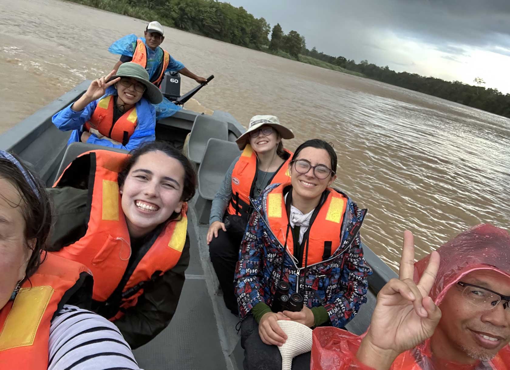Scripps College students, alums, and faculty on a boat in the Sabah region of Malaysia
