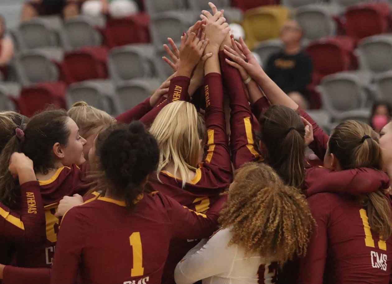 CMS Athenas volleyball team huddles during a game