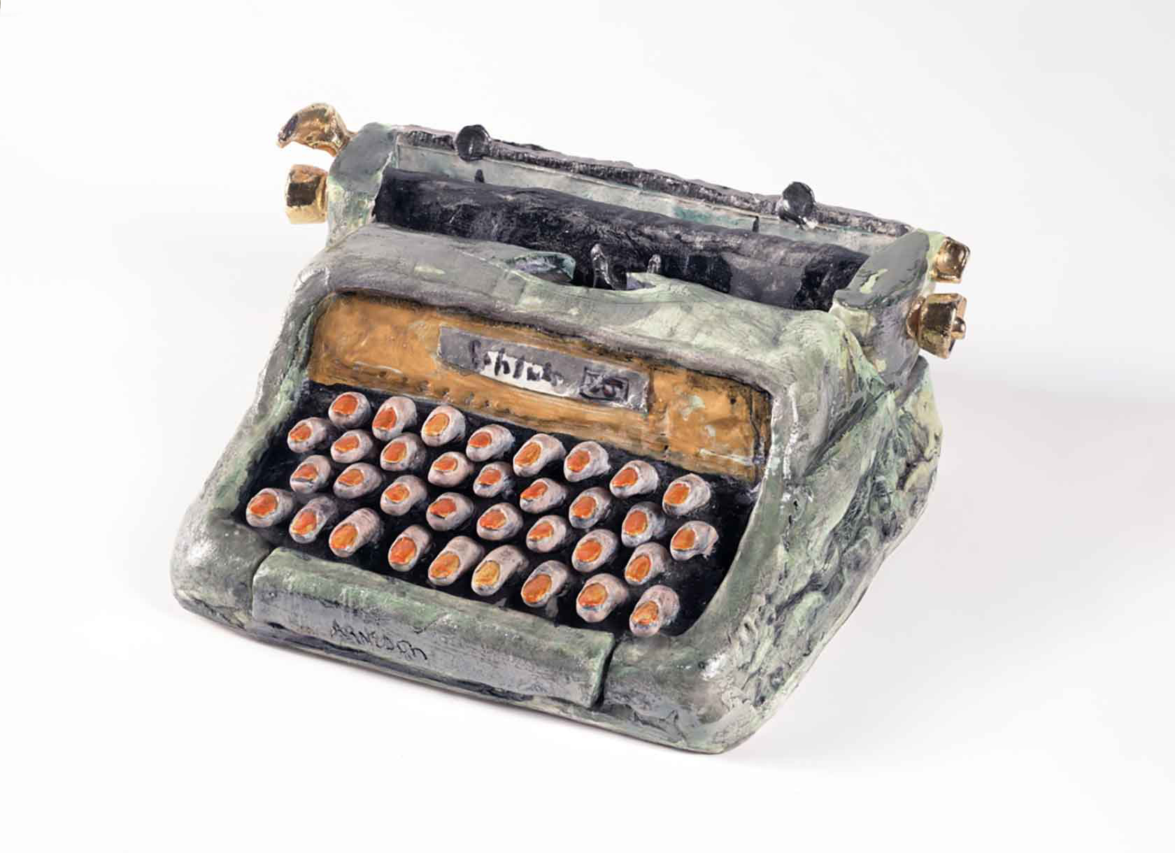Photo of a ceramic typewriter with fingers for keys