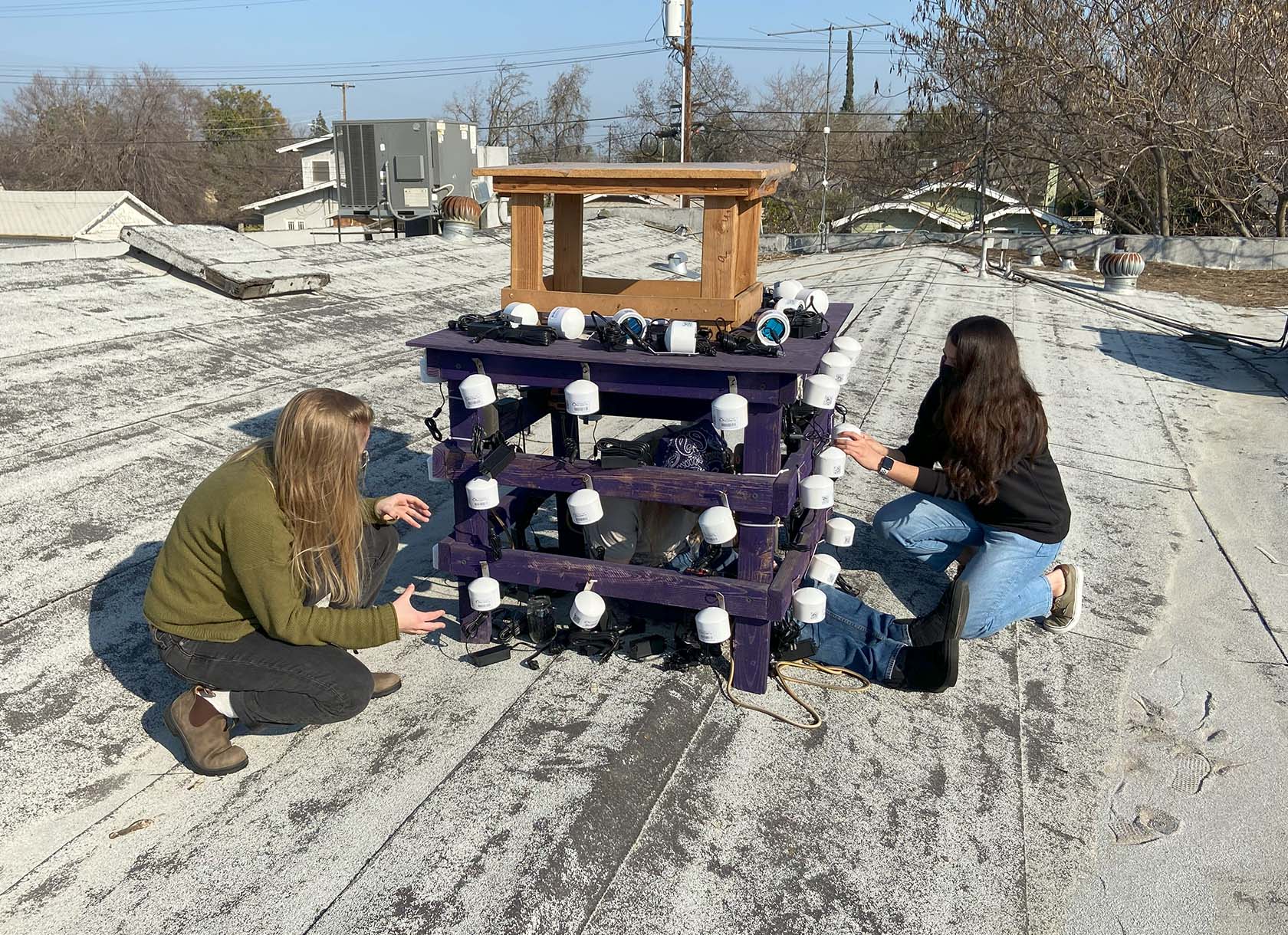 Kate DeMarsh '21, left, installing an air quality monitor.