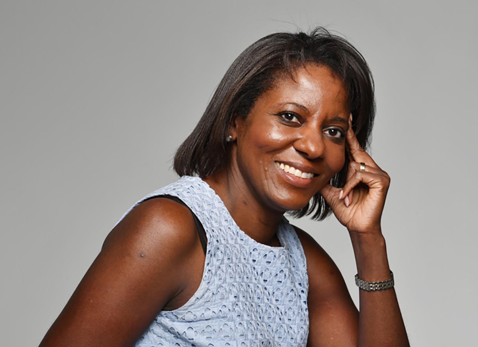 Close-up portrait of a Black woman leaning on her hand