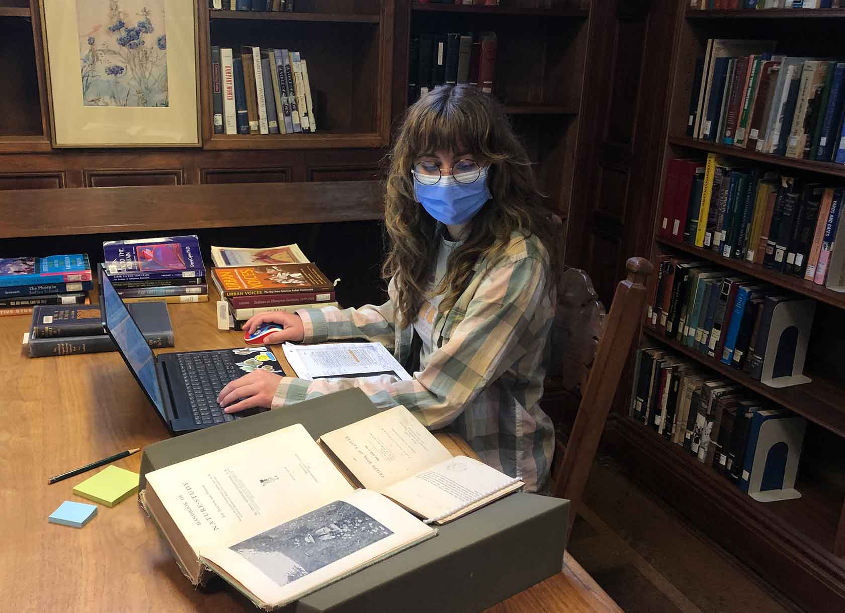 Portrait of Scripps College student Isabel Evans '23 conducting research in Denison Library