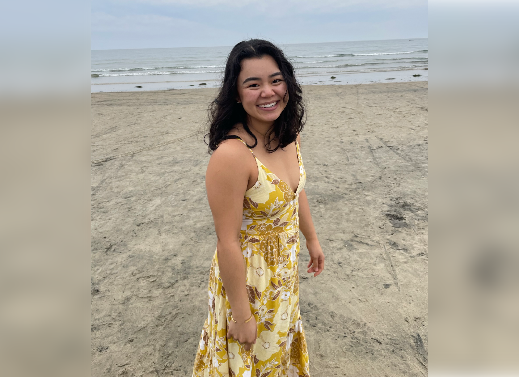 Photograph of Kimi Kaneshina '20 standing on the beach.