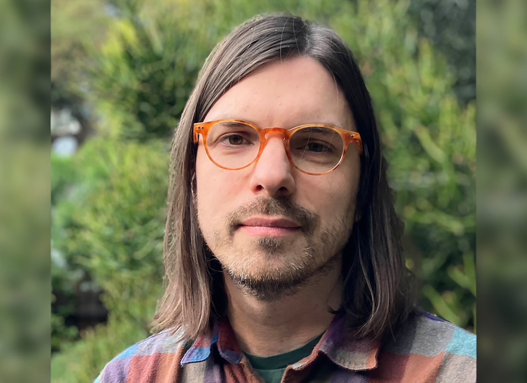Portrait photo of Assistant Professor of Philosophy Martin Glazier, a white man with brown hair and orange glasses.