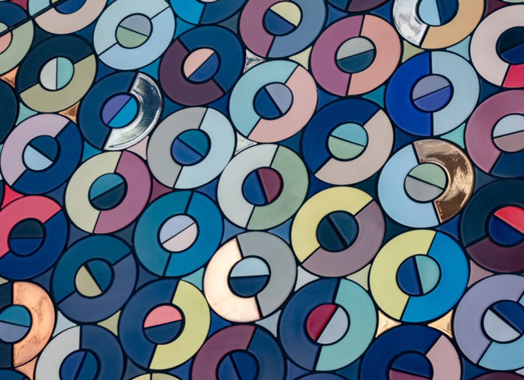 A graphic with rows of multicolored triangles and circular disks.
