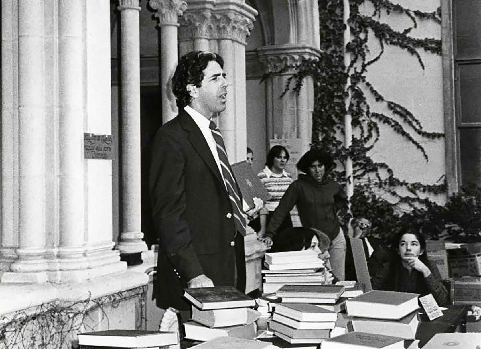 Professor Emeritus Richard Fadem oversees a book auction at Scripps College