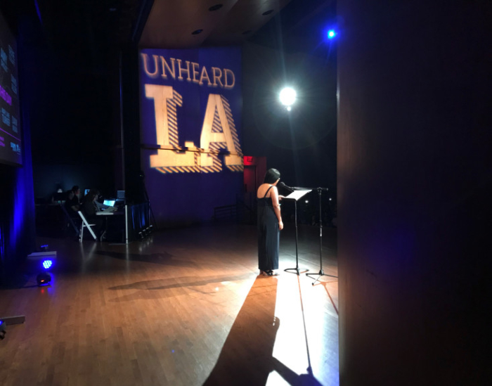 Scripps student Christy Orgeta speaking onstage in Garrison Theater.