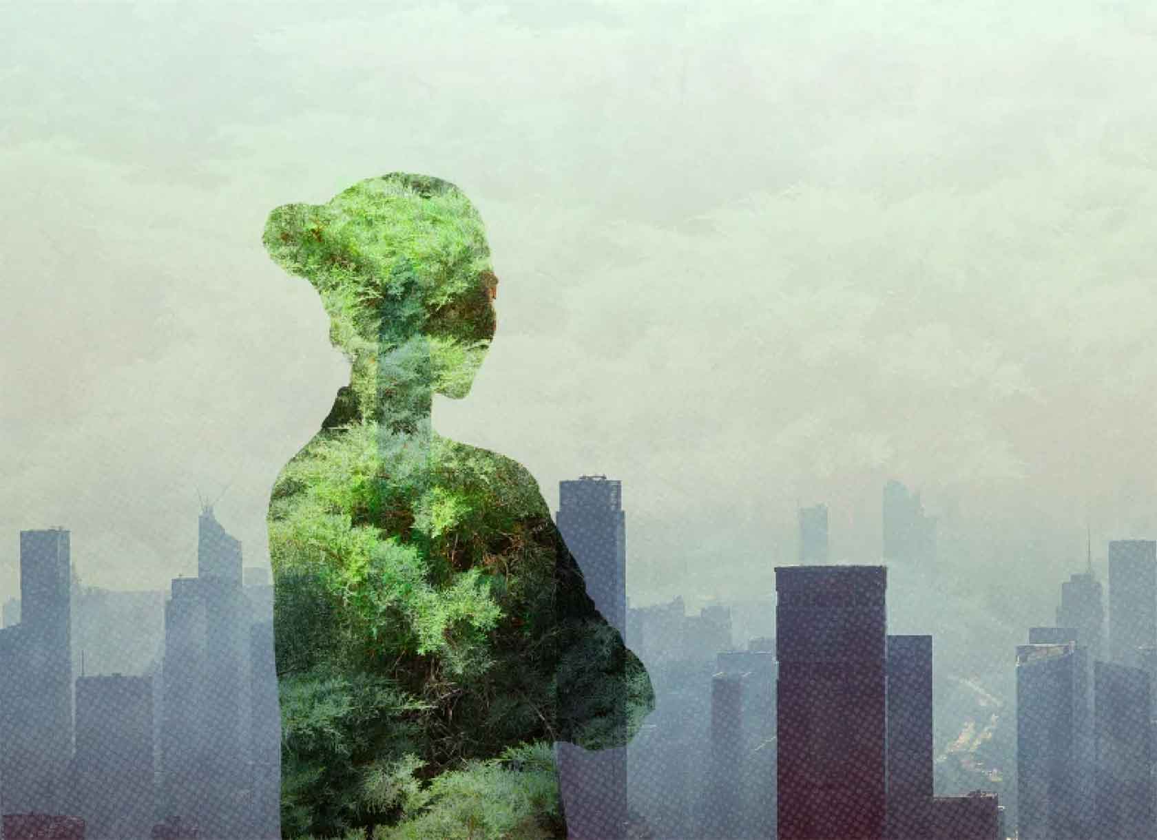 Double-exposure image of silhouette imposed over a forest and a city skyline