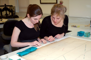 Robin Dubin and Dinah Parker examine tears at the edge of a 19th-century map from The Huntington's collection. Photo by Lisa Blackburn.