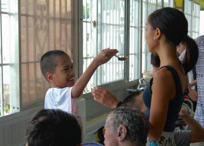 Maya Espiritu '16 volunteering with children 