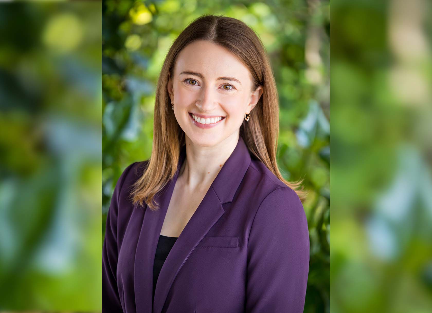 Portrait of Sarah Izant, a white woman with long brown hair.