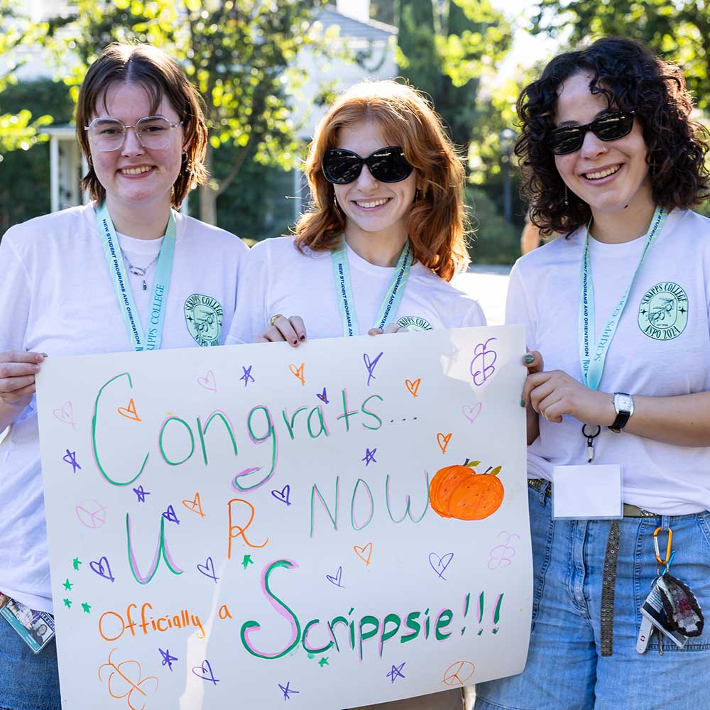 Students on Scripps campus with congrats sign