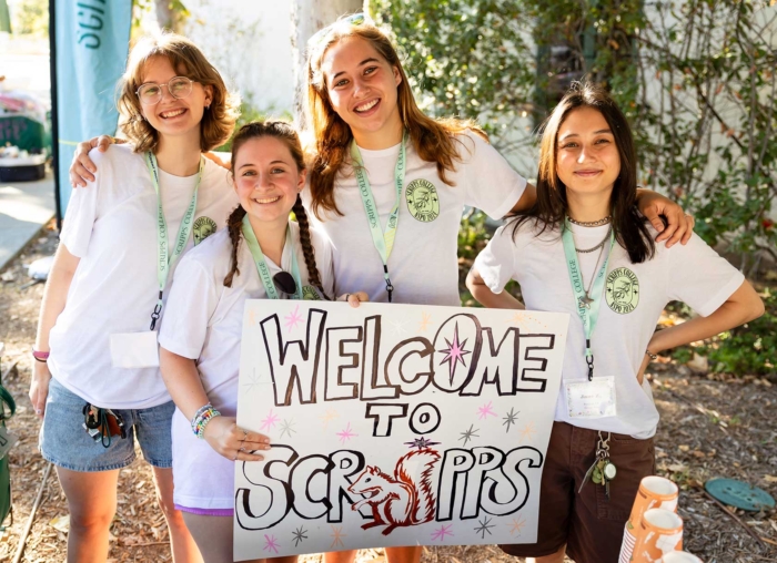 Students on Scripps campus with welcome to Scripps sign