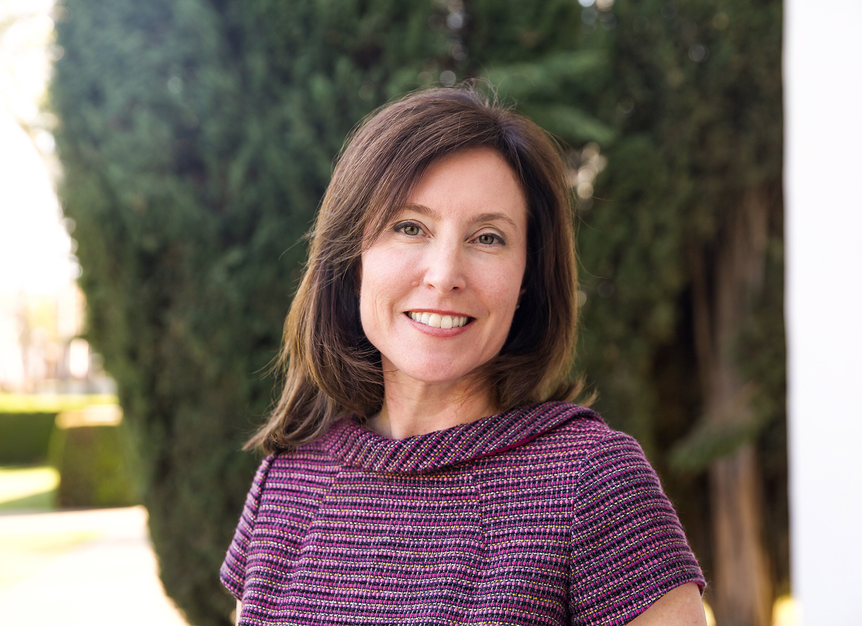 Portrait of brunette white woman in purple knit shirt