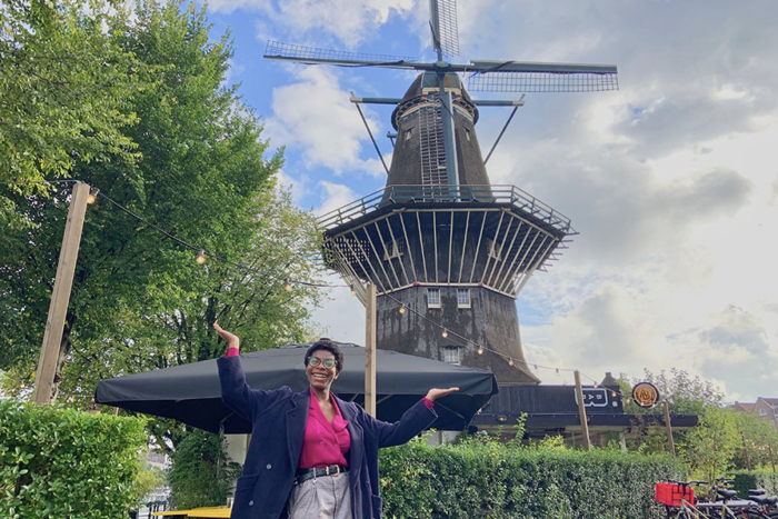 student abroad in the Netherlands standing in front of a windmill