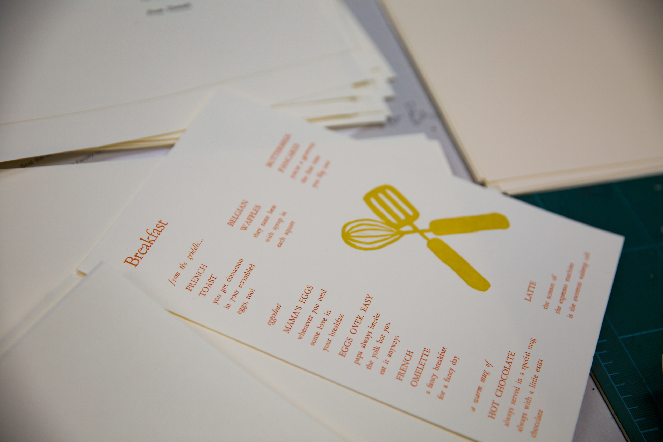 A dining menu in a stack of white papers.