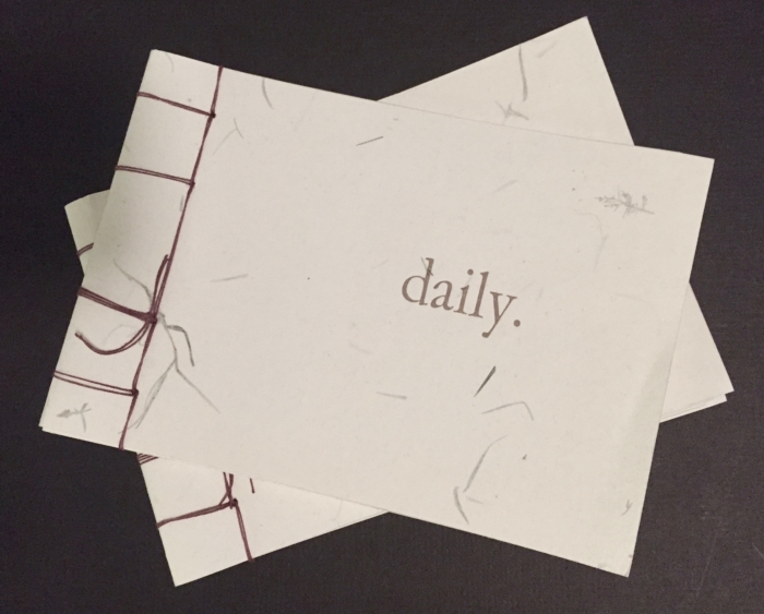 A sheet of paper with 'daily.' written on it.