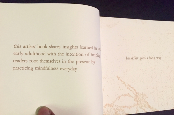 A person's hand turning the page of a book.
