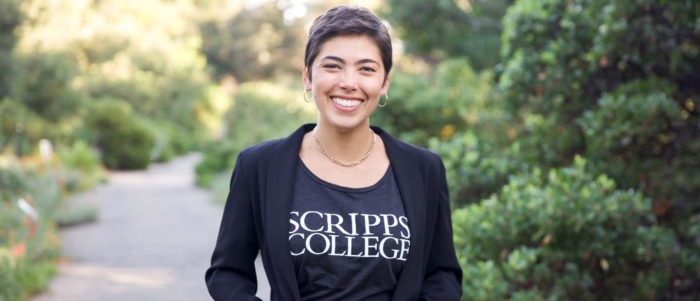 Student poses wearing Scripps College shirt on campus
