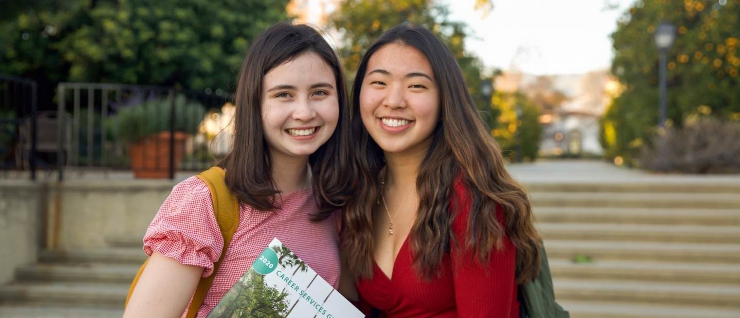 Two students smiling on campus at Scripps College, Claremont California