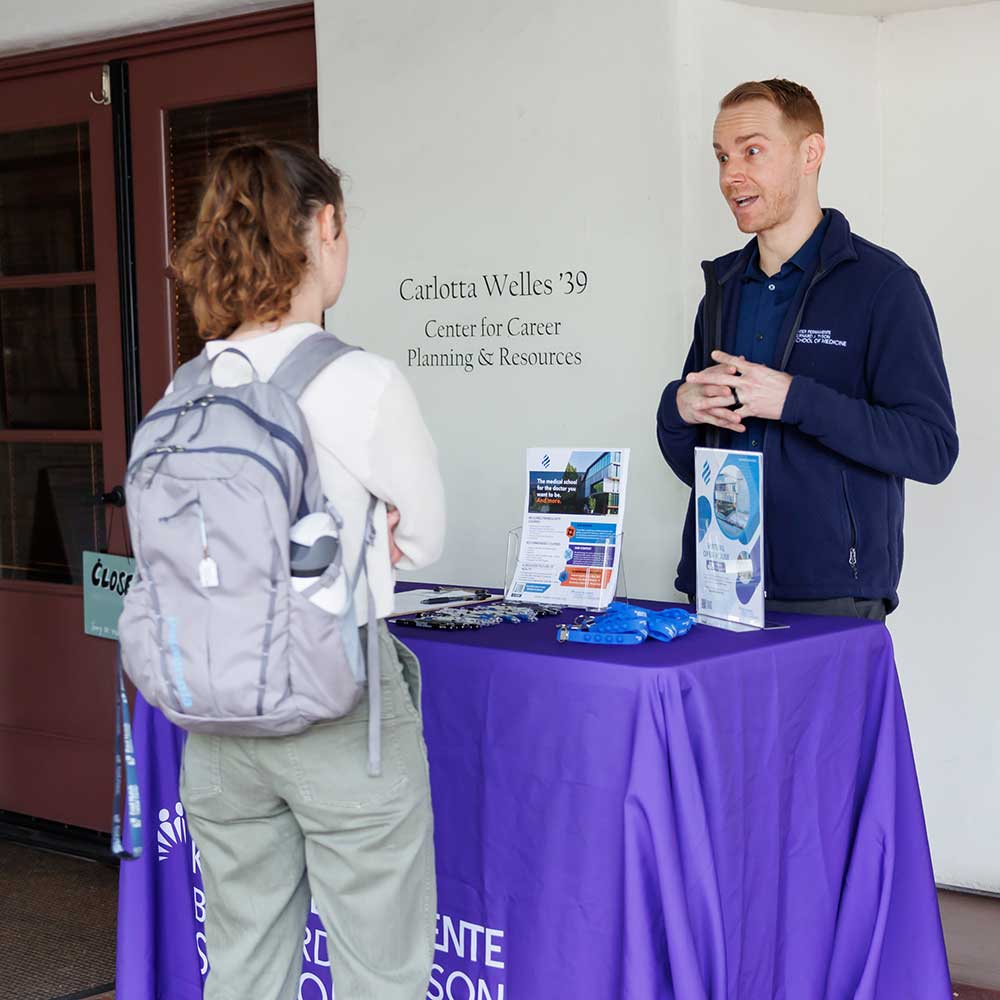 A recruiter speaking with a student