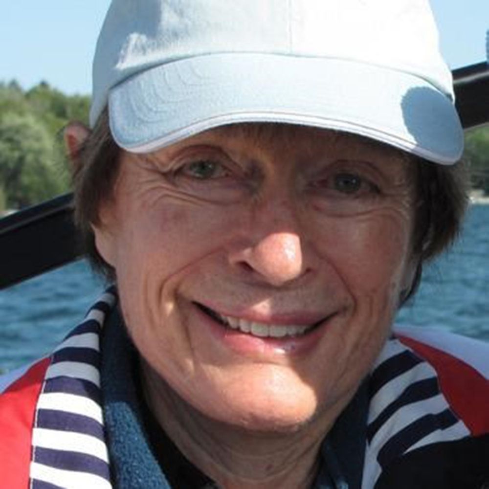Portrait of a smiling woman wearing a white baseball cap